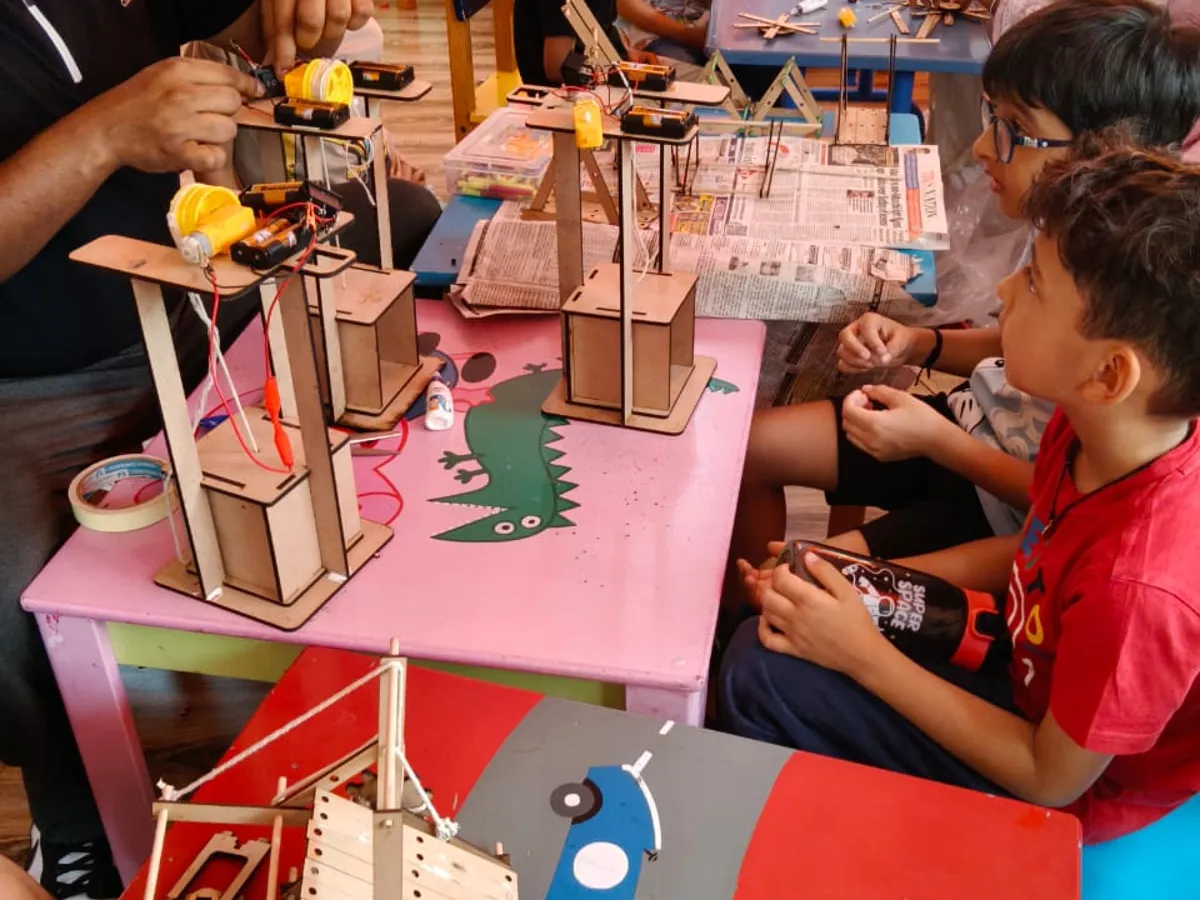 Children building motorised wooden towers