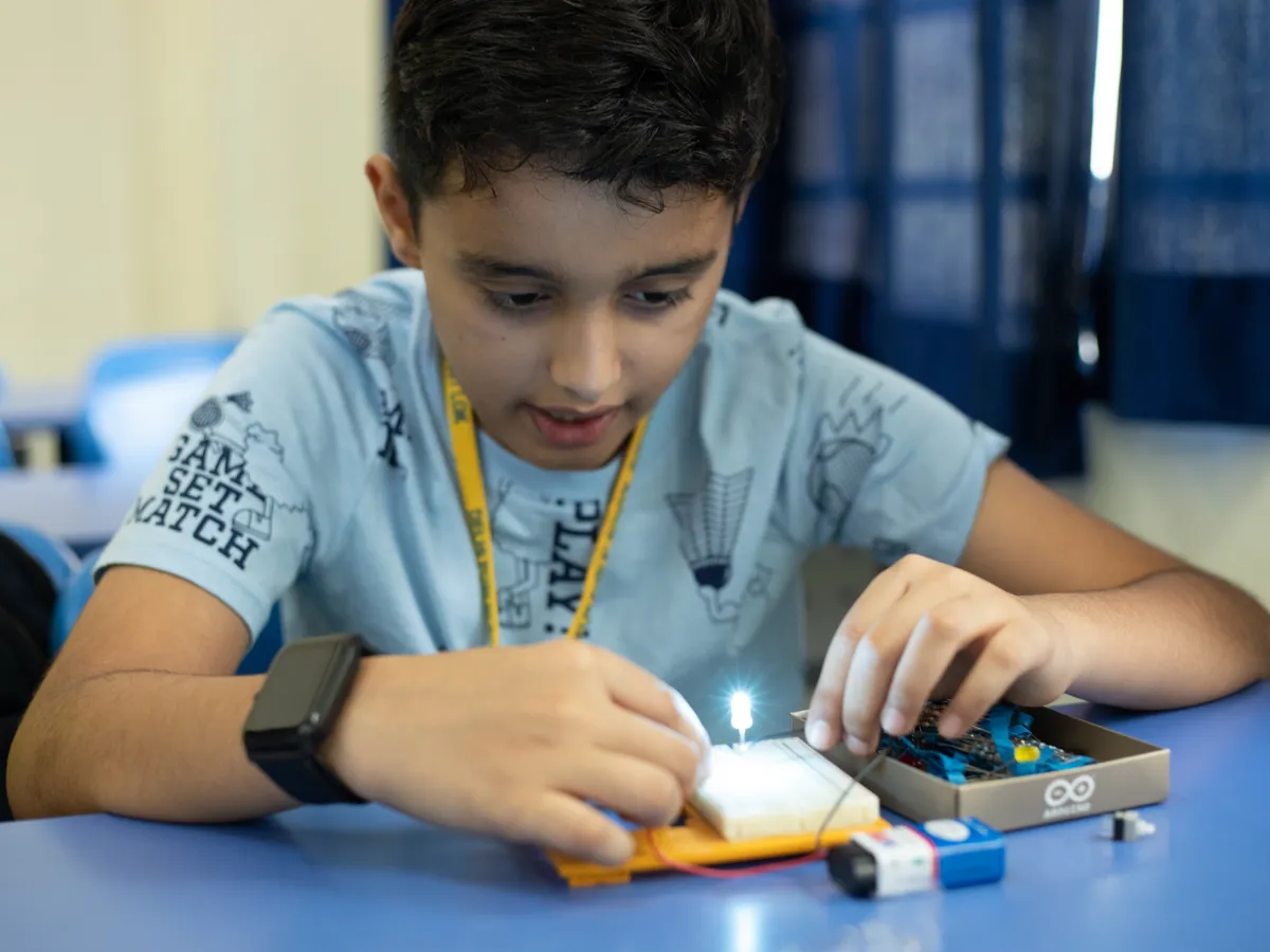 Child experimenting with an LED circuit